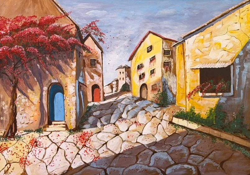 A quiet stone village lane with golden buildings, a bright blue doorway, red climbing flowers and irregular sunlit paving stones.